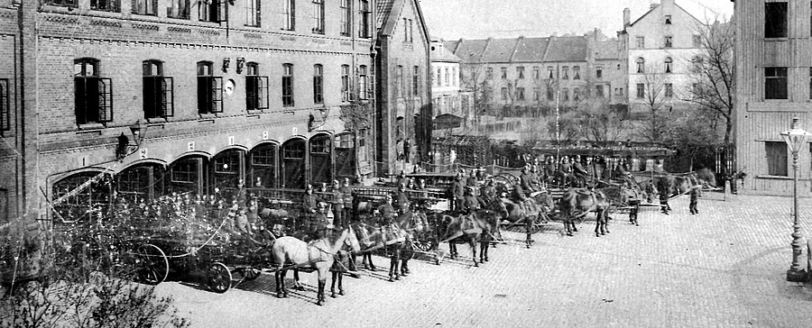 Ein Löschzug der Feuerwehr Bremen um 1820 mit Pferden vor einer wagenhalle